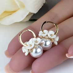 Elevate your special day with our exquisite Spring Blossom Floral Pearl Earrings. Delicately crafted to capture the essence of blooming flowers, these earrings are the perfect accessory to add a touch of elegance and charm to any outfit.Trendy Spring Style: Embrace the spirit of the season with our trendy floral pearl earrings, perfect for springtime gatherings, weddings, or everyday wear.Versatile Elegance: Whether paired with a casual sundress or a sophisticated evening gown, these earrings effortlessly enhance any ensemble with a touch of glamour.Handcrafted Quality: Each pair of earrings is meticulously handcrafted by skilled artisans, ensuring exceptional quality and attention to detail.Thoughtful Gift: Surprise a loved one with these beautiful pearl earrings, packaged in a cute gift Elegant Hypoallergenic Flower Pendant Jewelry, Elegant Hypoallergenic Flower Jewelry, Dangle Flower Earrings With 3d Flowers, Elegant Flower-shaped Hoop Earrings Gift, Elegant Rose Gold Flower Clip-on Earrings, Elegant Hypoallergenic Flower-shaped Earrings, Elegant Hypoallergenic Flower Shaped Earrings, Elegant Flower-shaped Hoop Earrings For Anniversary, Wedding Clip-on Flower Earrings