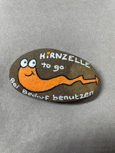 a rock with an image of a snail on it that says, harnelle to go