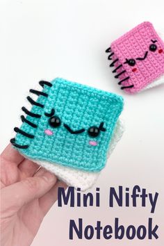 two small crocheted notebooks with faces on them and the words mini nifty notebook written below