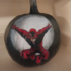 a painted pumpkin with a deadpool on it