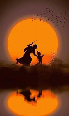 the silhouette of a woman and child in front of a sunset