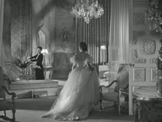 a woman in a wedding dress standing next to a man