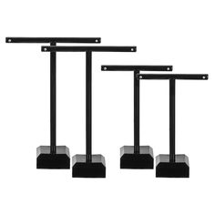 three black metal poles with square bases