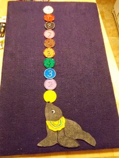 a child's art project made out of felt with buttons on the bottom and in the middle