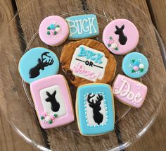 decorated cookies on a clear plate with words and pictures in the middle, including deer