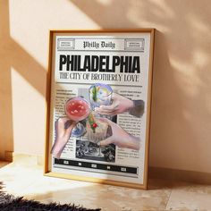 a poster is on the wall in front of a window that reads philadelphia, the city of brotherly love