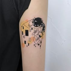 a woman's arm with a tattoo on it that has an image of a cat