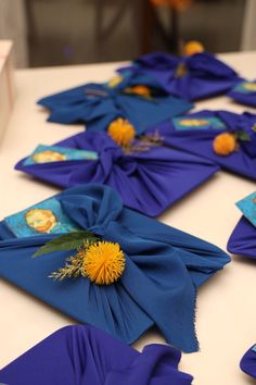 blue napkins with yellow dandelions are laid out on a white table top