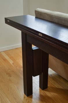 a wooden table sitting on top of a hard wood floor