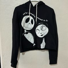 a black hoodie with an image of jack and sally from the nightmare