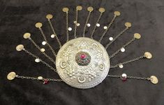 Mid Century, Ottoman  style Turkish authentic alpaga headdress / cap / headpiece tinned cover with dangles [chains and (motherofpearl & brass) flakes] and with a dome-shaped fligree decor and a red glass bead in the mid. Cover-cap is embossed with crescent-star and floral motives. *        13.5cm (5.1/4") in dia      -       dangles btw 12.5cm - 13.5cm (4.7/8"-5.1/4") in length Solid and in very good condition for age with some wear of use and with some missing dangles. (see all picts as complementary information to the item description) Collectable Home decor Hand made Adjustable Silver Costume Hats And Headpieces For Festival, Vintage Handmade Costume Hats And Headpieces For Gifting, Red Festival Crown Headpiece, Handmade Ceremonial Round Crown Headpiece, Bohemian Handmade Headpiece With Round Crown, Handmade Bohemian Headpieces With Round Crown, Handmade Bohemian Hats And Headpieces For Festivals, Bohemian Handmade Costume Hats For Festivals, Handmade Ceremonial Headpiece With Round Crown