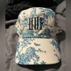 Huf Brand Baseball Cap. Adjustable Back. Cute White And Blue Antique Flower Pattern. Only Tried On Never Worn. Kept In Smoke/Animal Free Home. Blue Visor Baseball Cap For Spring, Blue Curved Visor Dad Hat For Summer, Blue Summer Dad Hat With Curved Visor, Casual Cotton Hats With Floral Print, Blue Baseball Cap With Curved Visor For Spring, Casual Floral Print Cap, Blue Curved Brim Dad Hat For Spring, Casual Hat With Curved Brim And Floral Print, Casual Floral Print Hat With Curved Brim