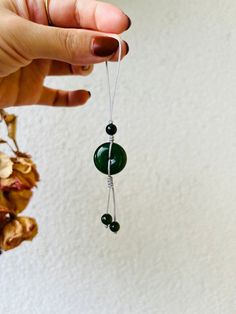 A simple handmade phone charm made of a Hetian jade saft clasp with a beautiful green color. Size of the saft clasp: 18mm x 18mm x 8mm Knowledge about jade behind the scences: As its name suggests, the "Saft Clasp" is believed to bring peace, safety, and blessings to the wearer.  The gourd is a symbol of longevity, good health, and prosperity in Chinese folklore, and combining it with jade enhances its auspiciousness and beauty. Jade gourds are often worn as jewelry or displayed as decorative it Chinese Folklore, Chinese Jade, Phone Plug, Hetian Jade, Phone Charm, Green Colors, Dark Green, Poland, Cell Phone Accessories