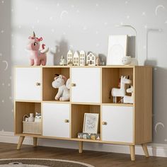 a white and wooden shelf with toy animals on it in a child's room