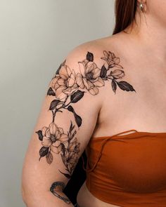 a woman's arm with flowers on it