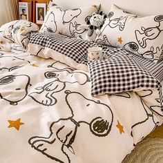 a bed covered in black and white cartoon sheets