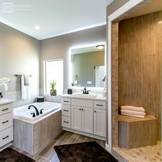 a large bathroom with two sinks and a bathtub