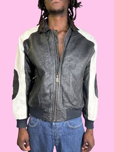 This is a 1990s treasure. The 8 ball jacket, made by Michael Hoban symbolizes taking risks and winning. Careful walking around in this jacket, known in the 90s to be so sought after than people would be robbed at knifepoint for it! The jacket itself is in the white and black color way, has two zip pockets on the front, the front zipper says "wherem.i" in the shape of shield, and has three total leather 8-balls. The largest is across the back, with the other two on the sleeves. Designer: Michael 90s Style Leather Jacket For Winter Streetwear, 90s Style Leather Jacket For Fall Streetwear, 8 Ball Jacket, Taking Risks, 8 Ball, The 8, The 90s, British Indian, Front Zipper