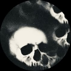 a black and white photo of two skulls in a circle with their faces slightly open