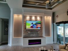 a flat screen tv mounted on the wall in a living room