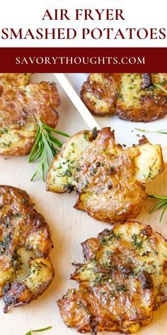 air fryer smashed potatoes on a cutting board with rosemary sprigs and seasoning