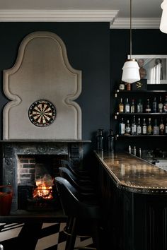 a dart board mounted to the side of a wall next to a fire place in a bar