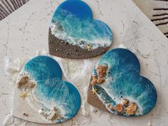 three heart shaped cookies sitting on top of a table