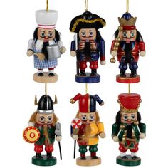 four nutcrackers are hanging from strings