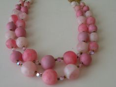 "Very good condition. Probably unmarked Coro. Pink satin or matte plastic, pink ab crystals, metal beads. Shortest strand - 18\" with hook and extender. 19.5\" longest strand. Beads diameter - 10, 12, 15, 20 mm." Pink Double Strand Beaded Necklace With Faceted Beads, Pink Double Strand Faceted Beaded Necklaces, Pink Necklaces With 8mm Beads, Pink Double Strand Faceted Bead Necklace, Pink 8mm Beaded Necklace, Cheap Pink Multi-strand Beaded Necklaces, Pink Hand-strung Round Beads Necklace, Pink Multi-strand Beaded Necklace With Faceted Beads, Christmas Tree Necklace