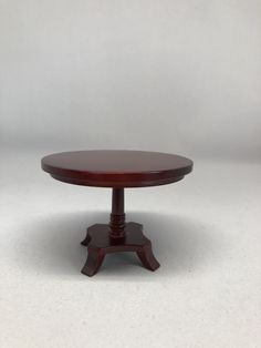 a small wooden table sitting on top of a white floor