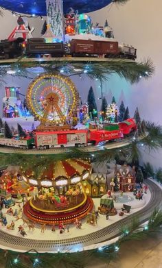 the christmas tree is decorated with miniature trains and other holiday decorations, including santa's sleigh