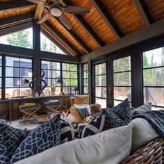 a living room filled with furniture and lots of windows