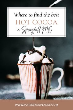 a cup filled with ice cream and chocolate on top of a table next to a sign that says where to find the best hot cocoa in simply mo