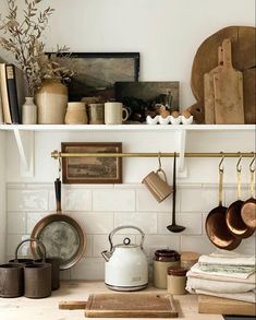 pots, pans and other kitchen items are on the shelves above the stove top