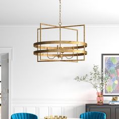 a dining room table with blue chairs and a chandelier hanging from the ceiling