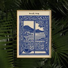 a blue and white tile hanging from the side of a palm leaf covered wall next to a potted plant