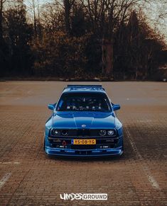 a blue car parked in a parking lot