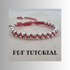 a red string bracelet with silver hearts on it and the words pdf tutorial written in