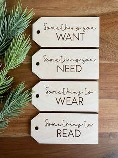 three wooden tags that say something you want, something you need and something to read