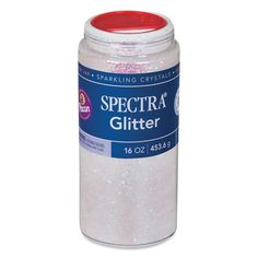 a white jar filled with glitter sitting on top of a table next to a red lid