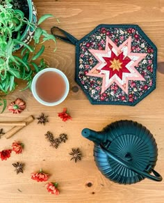 a wooden table topped with a tea pot and other items