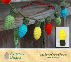 crocheted christmas lights hanging from a wooden fence with text overlay that reads, strand of christmas lights