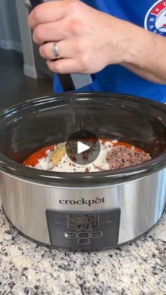 a person is cooking food in a crock pot