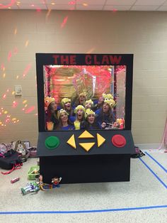 a group of people standing in front of a video game screen with the words the claw on it