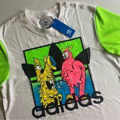 Brand New With Tags! Please Revise All Measurements Carefully! Details: - Lightweight - Graphic Print On Chest - Body Of Shirts Has Cotton Feel To It - Neon Green Sleeves Have Activewear Feel To It - Embroidered Pink Adidas Logo On Back Style Code: H53371 Let Me Know If You Have Any Questions And Make Sure To Check Out My Other Gnarly Finds! White Embroidered Graphic Tee, White T-shirt With Embroidered Logo For Spring, Casual White Shirt With Embroidered Graphics, White Casual Shirt With Embroidered Graphics, White Cotton Shirt With Embroidered Graphics, White Casual Shirt With Embroidered Logo, White Cotton Shirt With Embroidered Logo, White Crew Neck Shirt With Embroidered Logo, Jeremy Scott