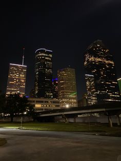 the city skyline is lit up at night