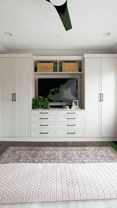 a living room with white cabinets and a rug