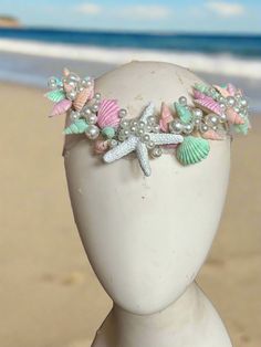 Shimmery Shells Pastel Circlet Mermaid Crown by The Head Mistress Transform into a sea diva with our Shimmery Shells Pastel Circlet Mermaid Crown by The Head Mistress! Embrace the enchanting allure of the ocean with hand-painted shells, glitter accents, bubble beads, and delicate natural moonstone chains. Main Features: Hand-painted Shells: Each shell is meticulously painted for a unique and mesmerizing look. Glitter Accents: Sparkle like the sea under the sunlight with subtle glitter detailing. Sea Witch Crown, Sea Shell Outfit, Witch Crown, Bubble Beads, Mermaid Crown, Fabric Photography, Painted Shells, Sea Witch, A Sea