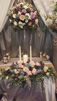 a table with flowers and candles on it