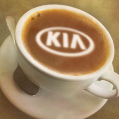 a cup of coffee with the word kin on it's foamy surface